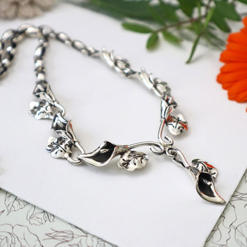 A UK 925 sterling silver unique handmade Mexican calla lily flower necklace on a white background.
