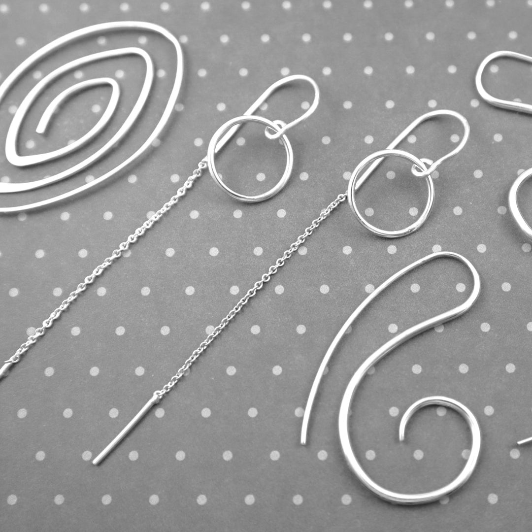 Long 925 silver threader and pull though earrings on a grey background 