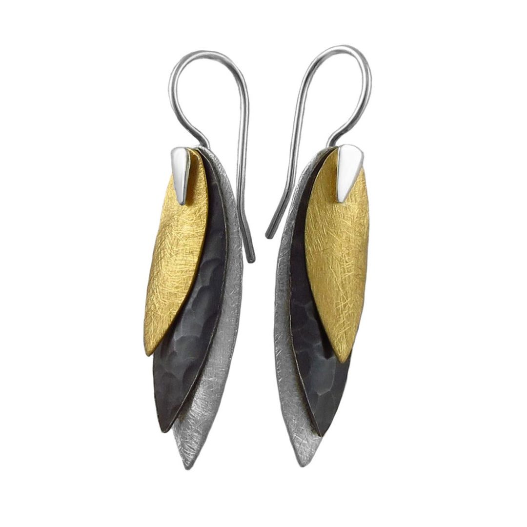 Pair of earrings with mixed metal gold and 925 silver leaf-like drops on a white background