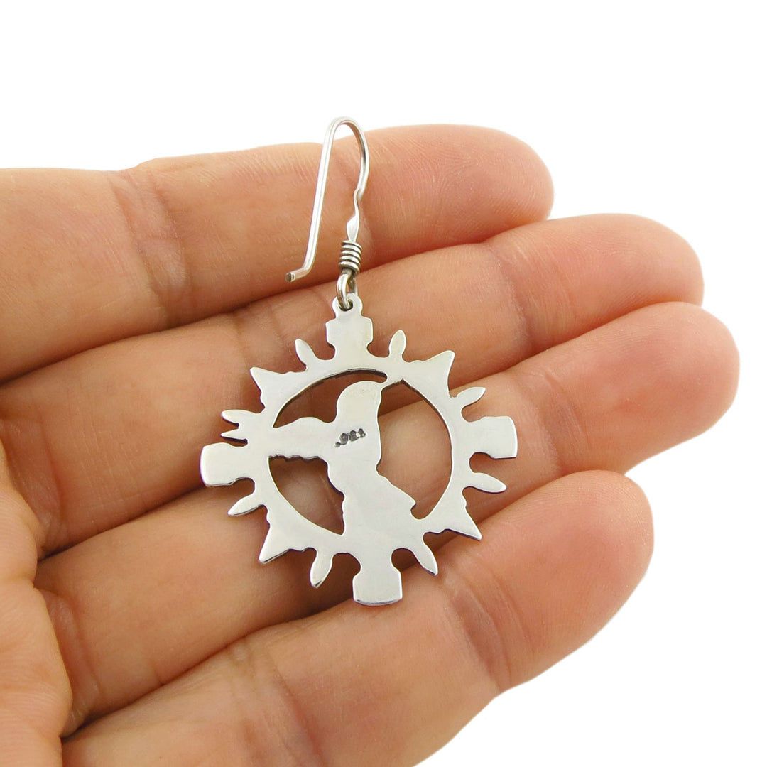 Large 925 silver circle earring held upside down in a person's hand to show the 925 hallmark