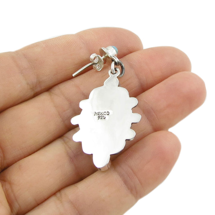 Reverse of a 925 silver earring held between fingers with 'Mexico 925' hallmark visible