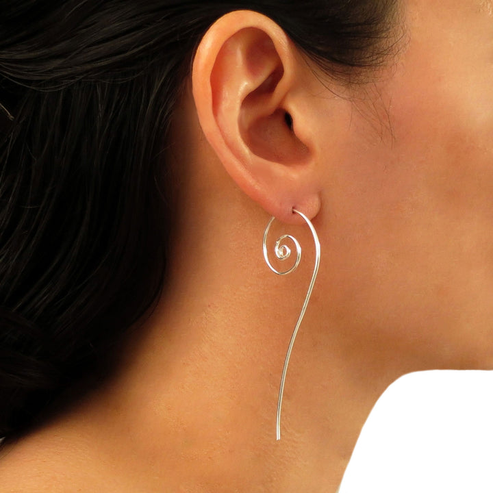 Long coiled spiral 925 sterling silver threader earrings worn by a woman with dark hair