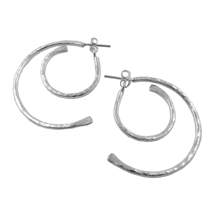 Pair of large handmade hammered 925 sterling silver hoop earrings on a white background