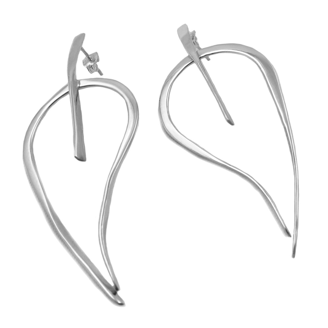 Pair of silver earrings in the shape of large tree leaf motifs on a white background