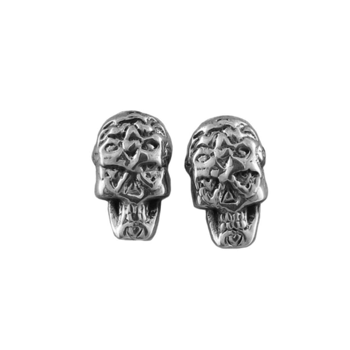 Pair of sterling 925 silver skull-shaped stud earrings on a white background