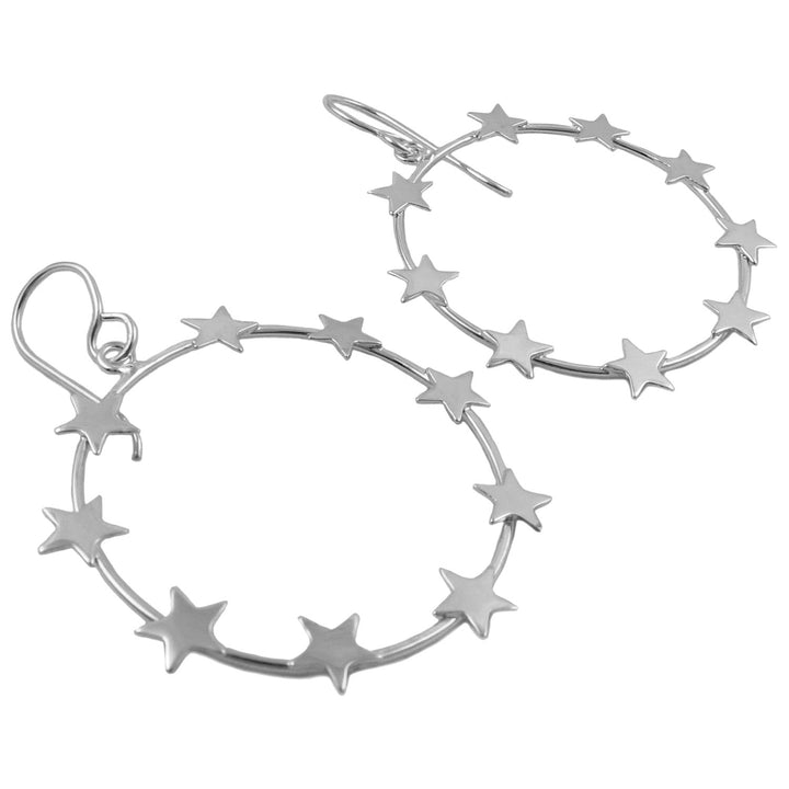 Sterling silver hoop earrings decorated with multiple small star cutouts, displayed on a clean white background.