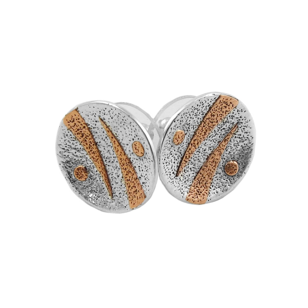 A pair of round mixed metal stud earrings with a textured pitted 925 silver finish, accented by diagonal copper stripes and small dots, shown on a plain white background.