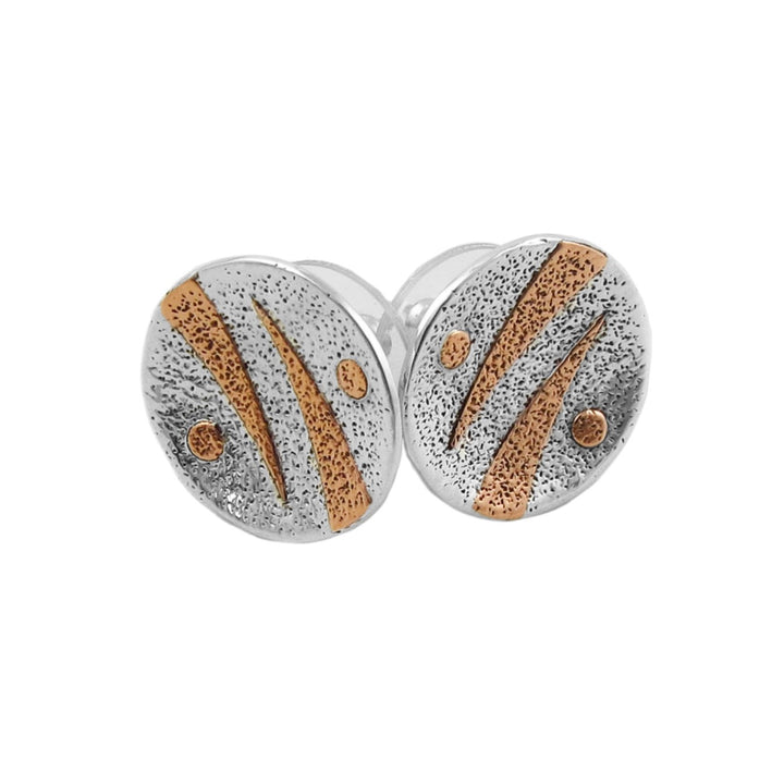 A pair of round mixed metal stud earrings with a textured pitted 925 silver finish, accented by diagonal copper stripes and small dots, shown on a plain white background.