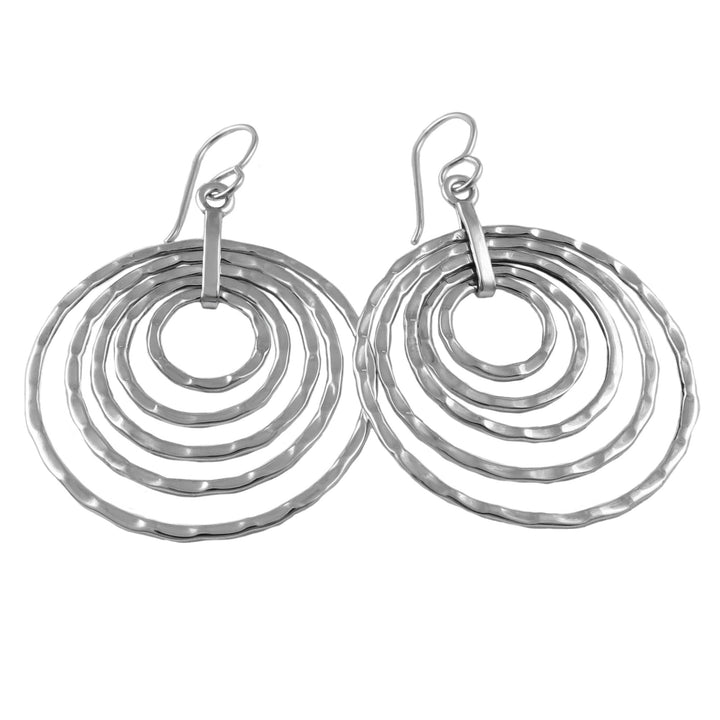 Silver multi hoop drop earrings on a white background