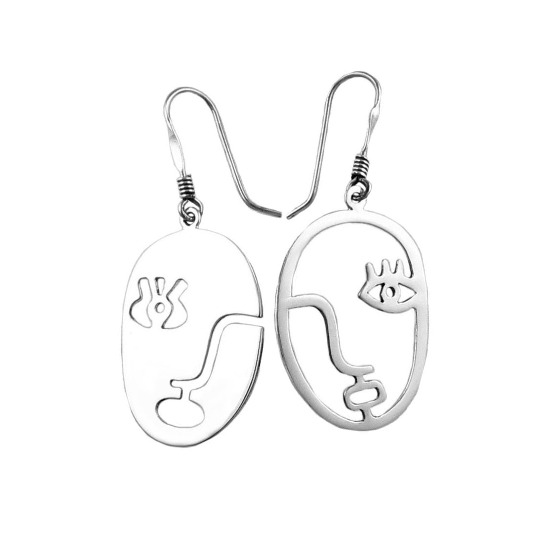Pair of silver earrings with abstract female face designs on a white background
