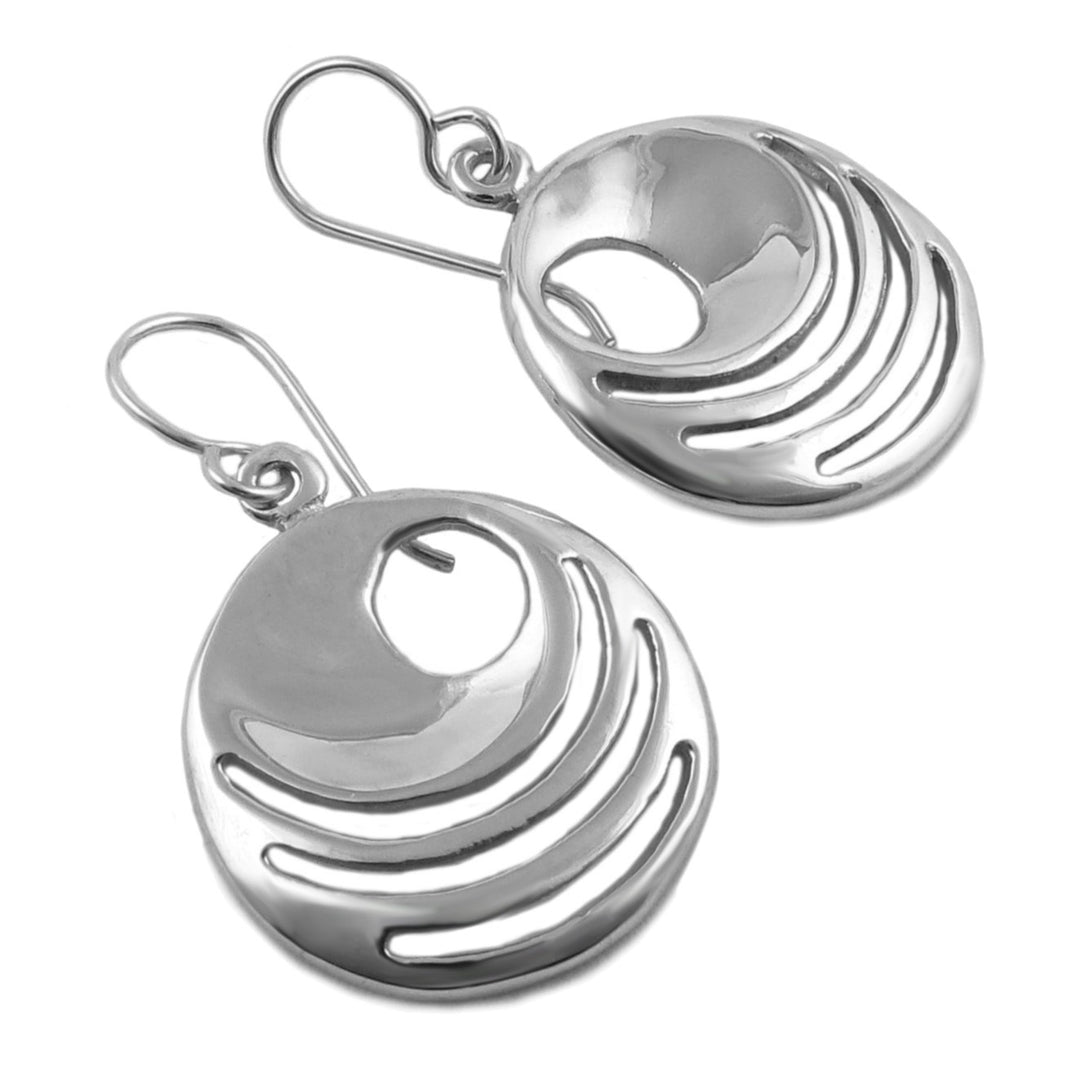 Pair of silver earrings with a circular design on a white background