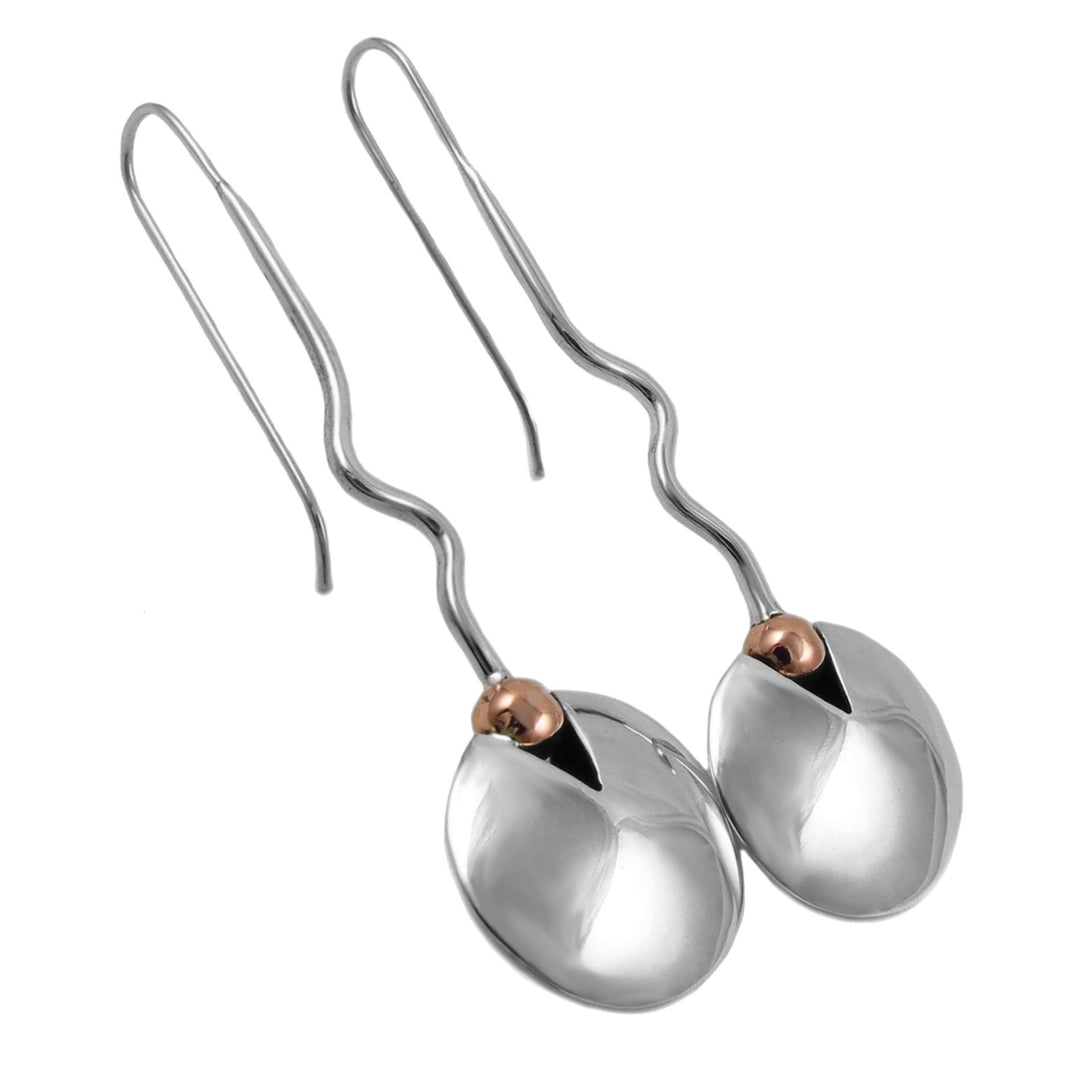 Circle earrings with copper accents and long curved threader hooks  on a white background.