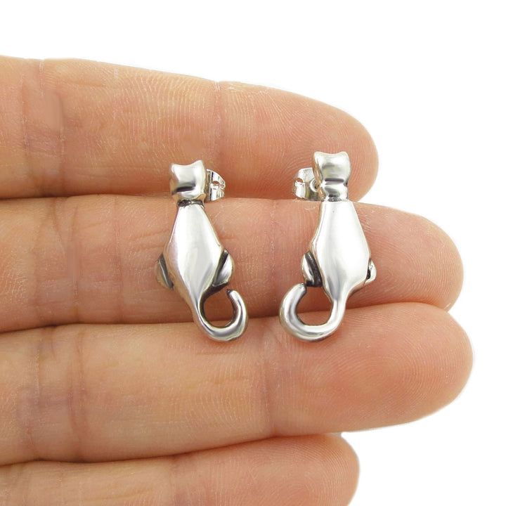 Cat lover 925 sterling silver earrings held between fingers on a white background