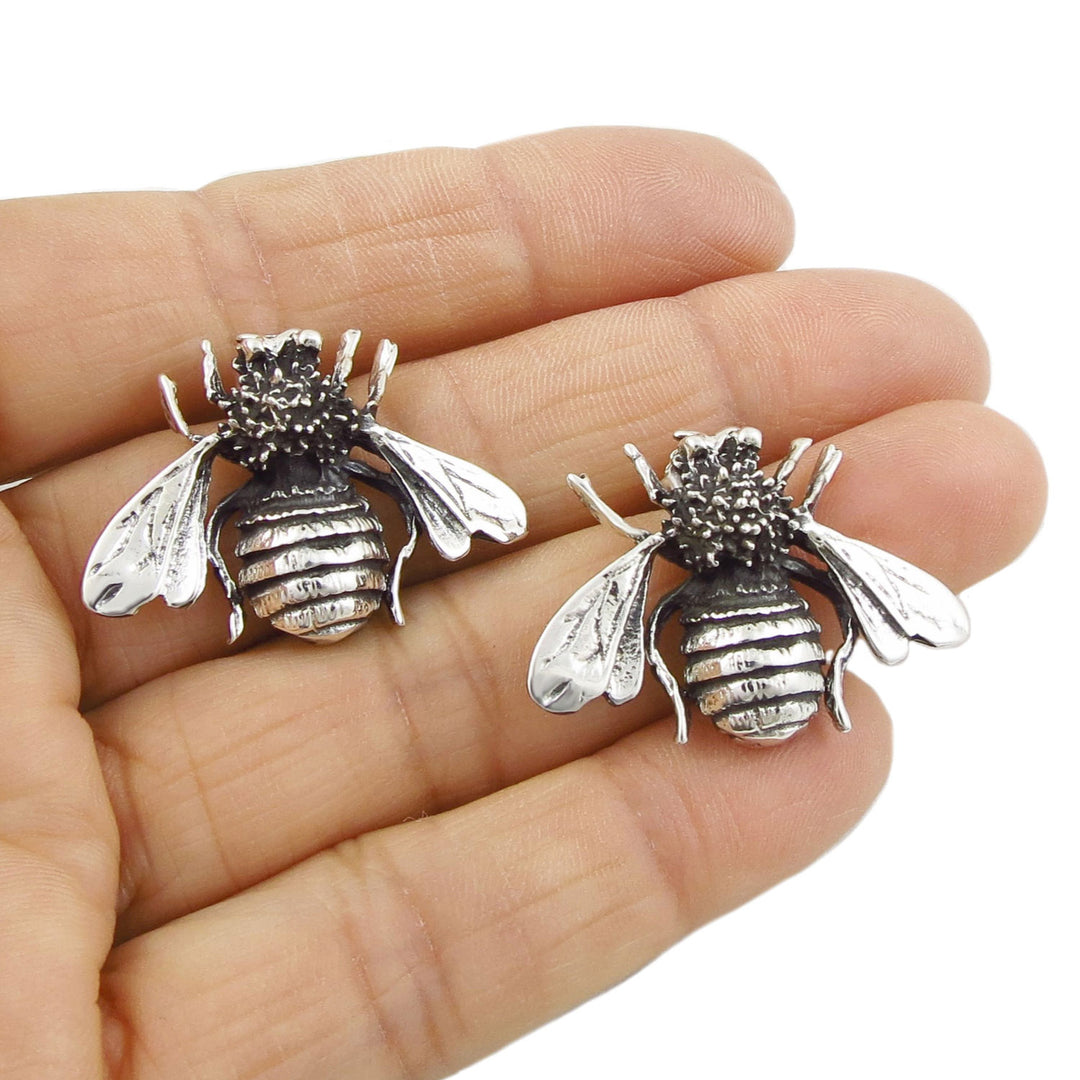 Large Mexican Taxco 925 sterling silver handmade bee stud earrings for women held in a  person's hand
