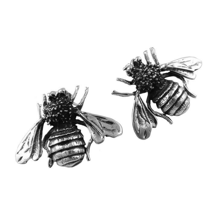 Large sterling 925 silver stud earrings in the shape of large bees on a white background. 