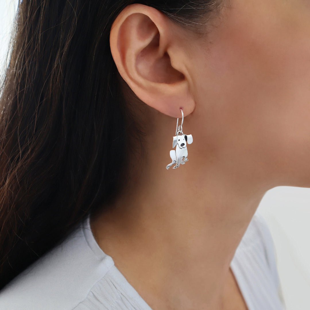 Woman with dark hair wearing a long 925 silver labrador dog earring. 