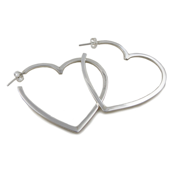 A pair of large 925 silver hoop earrings in the shape of love hearts on a white background 