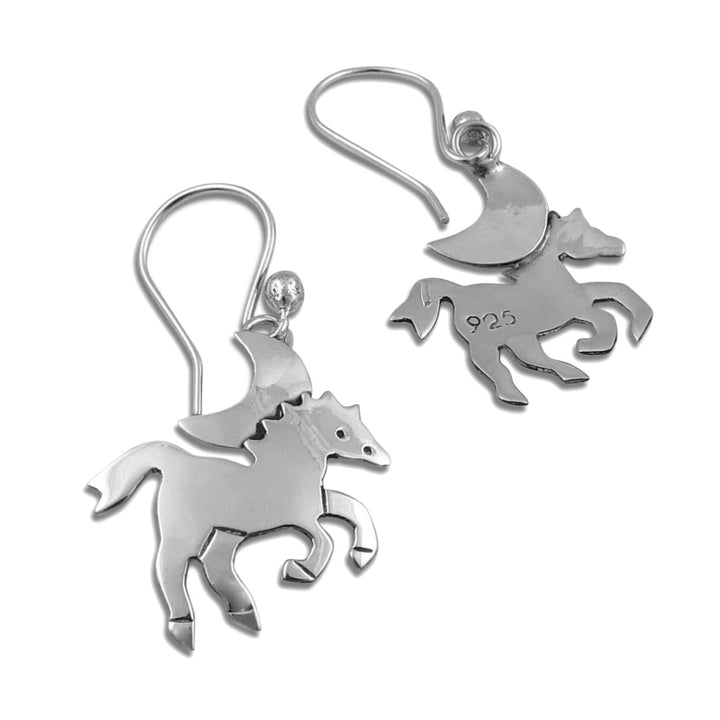 A pair of sterling silver dangle earrings featuring a silhouette design of a galloping horse, with a crescent moon above, shown on a plain white background.