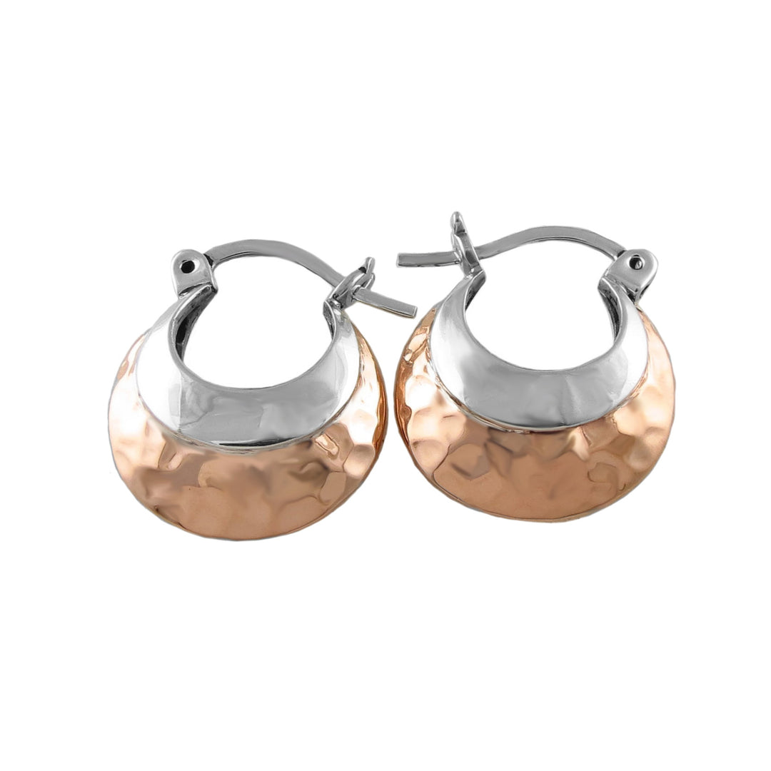 Pair of copper and silver hoop earrings on a white background