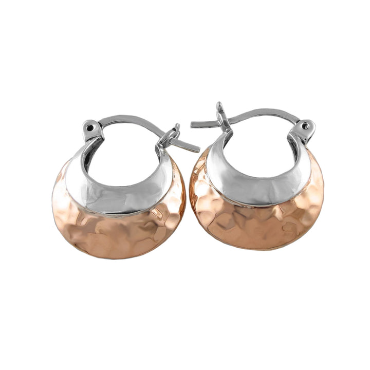 Pair of copper and silver hoop earrings on a white background