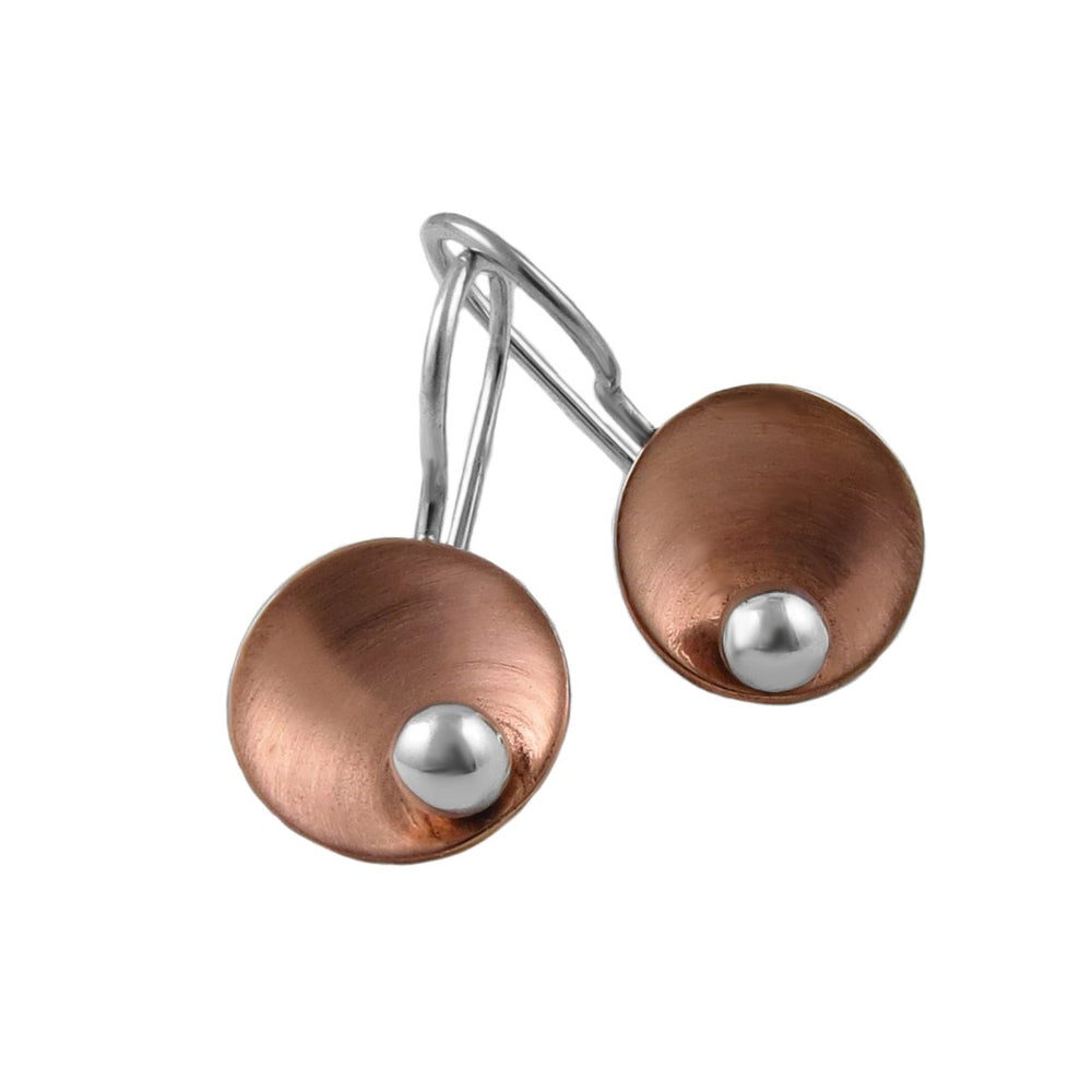 A pair of modern dangle mixed metal earrings featuring textured copper discs with polished silver ball accents and silver wire hooks, shown on a plain white background.