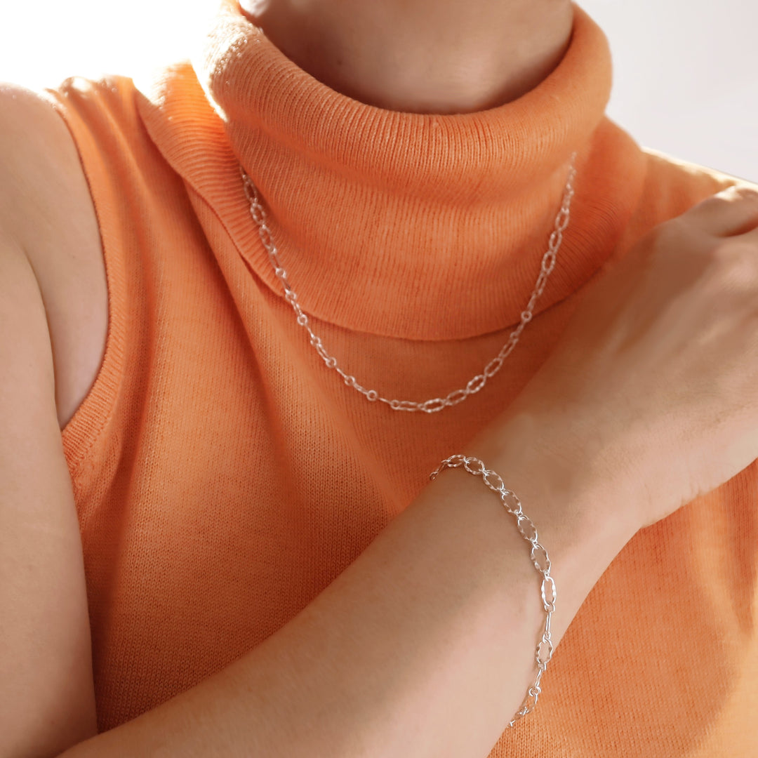 Silver oval link chain bracelet and matching necklace. 