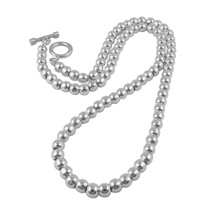 Silver beaded necklace on a white background