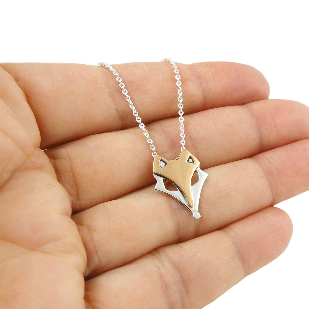 Two tone 925 silver and copper country style fox head pendant necklace for women on a circle link chain held in a person's hand. 