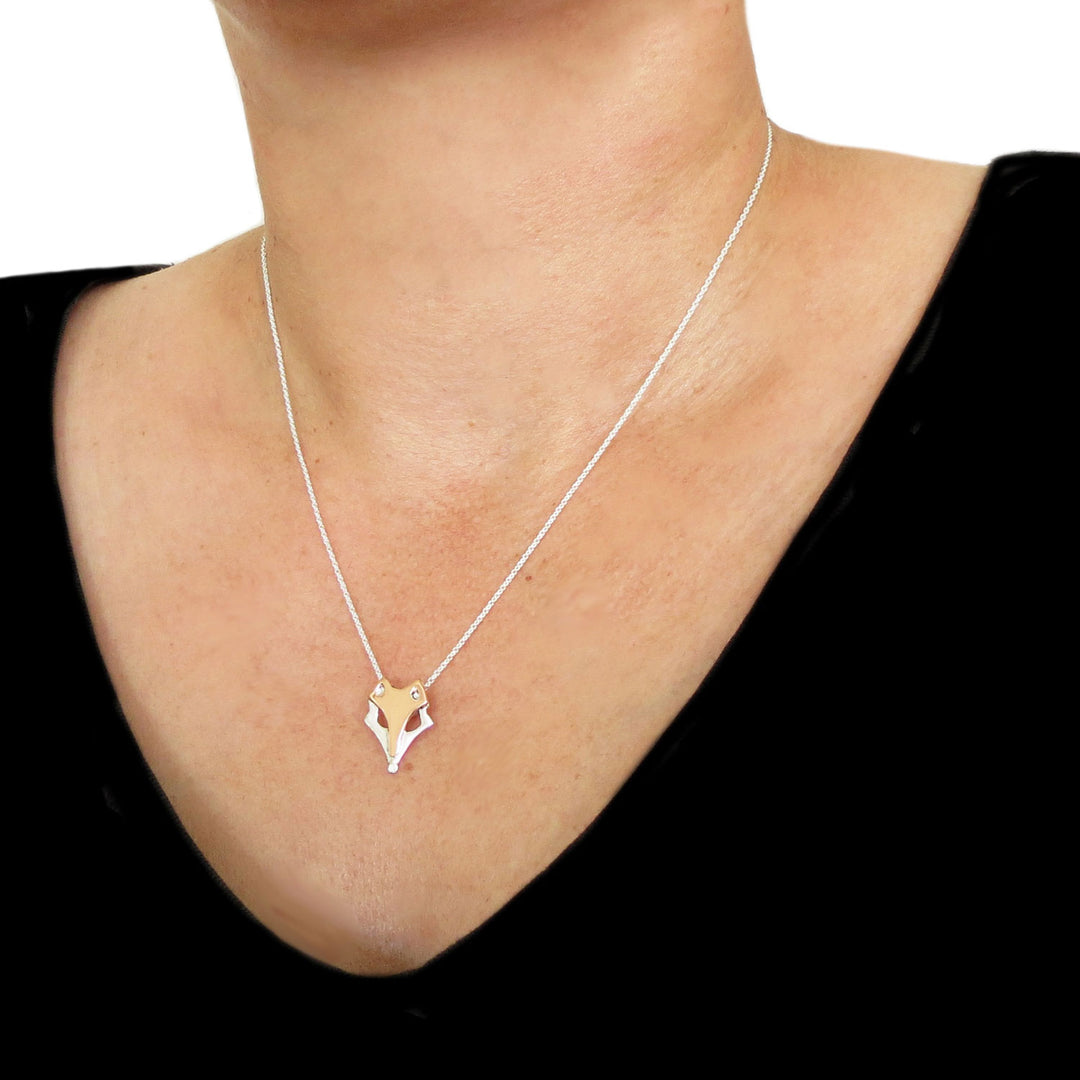 Mixed metal copper and 925 silver fox head pendant and circle link chain necklace worn by a woman in a black top.