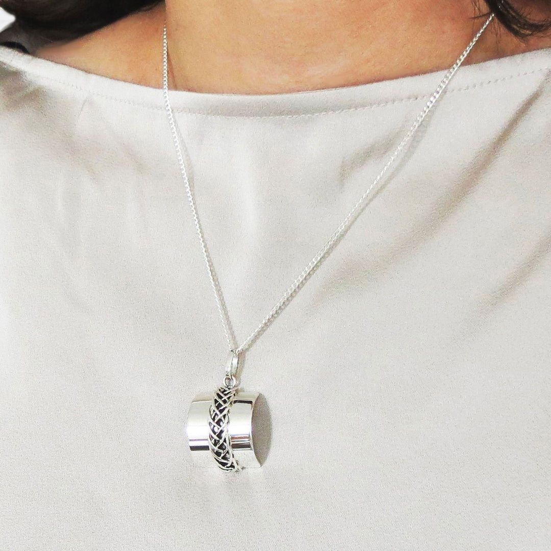 Taxco 925 sterling silver chain and rectangle pendant necklace worn by a woman in a white silk blouse