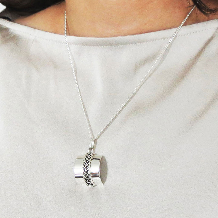 Taxco 925 sterling silver chain and rectangle pendant necklace worn by a woman in a white silk blouse