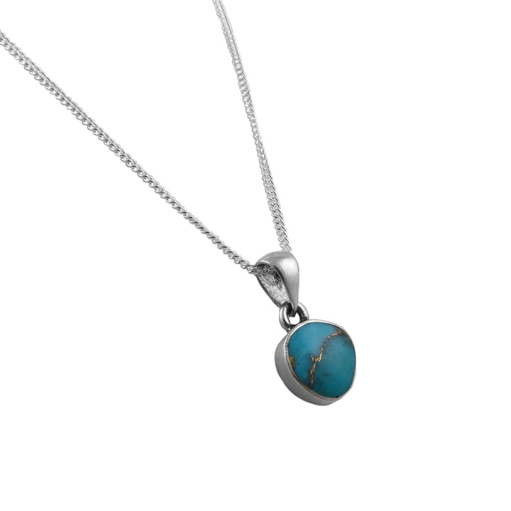 A turquoise gemstone pendant and silver curb chain necklace