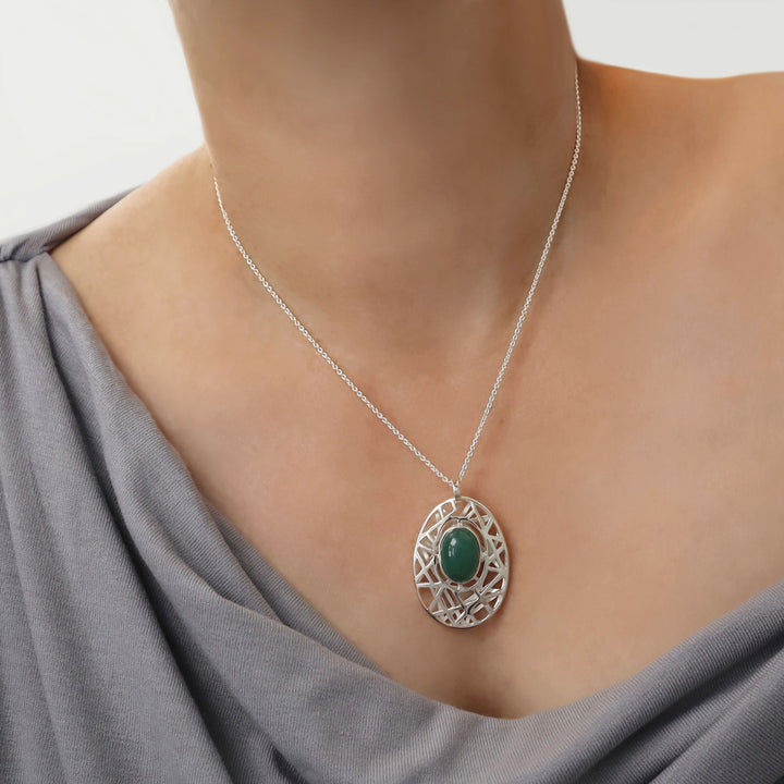 terling 925 silver chain and pendant Necklace with a green aventurine gemstone worn by a woman in a gray top.