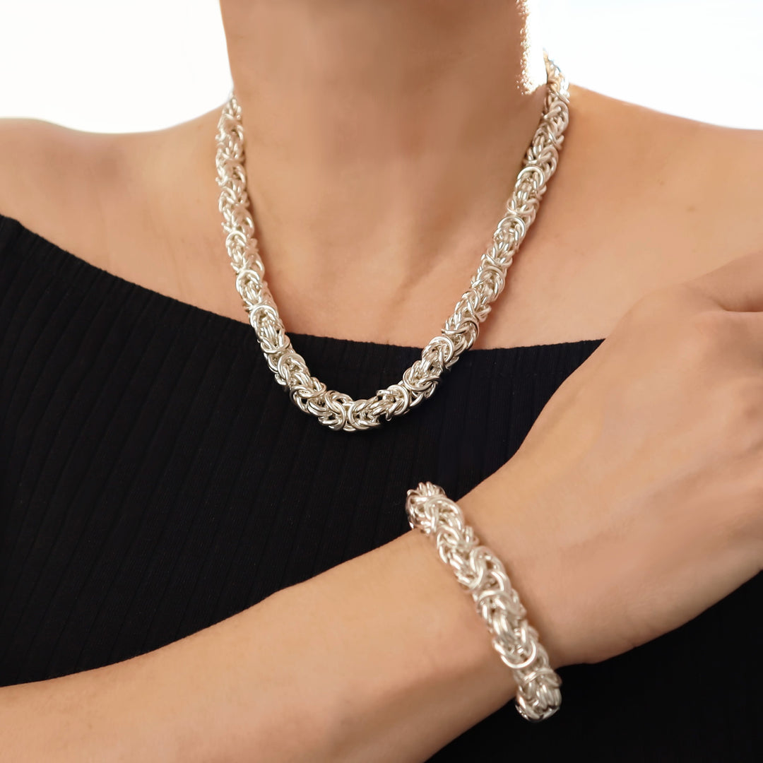 925 sterling silver byzantine chain necklace and bracelet on a person against a white background
