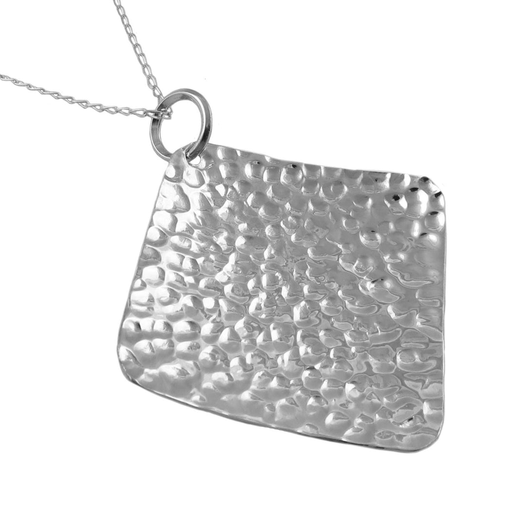 Large 925 sterling silver hammered square pendant on a curb chain against a white background