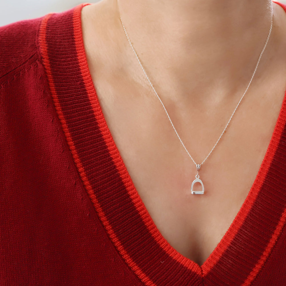 Solid 925 Silver necklace with a horse stirrup pendant worn by a woman in a red sweater.