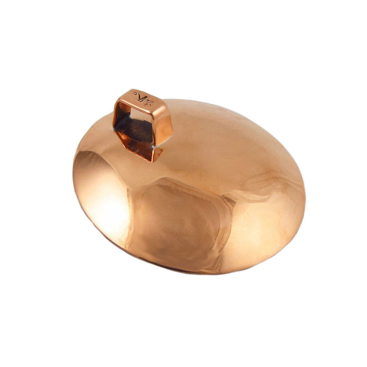 A copper pendant jewellery turned upside down to show a hallmark on the bail on a white background