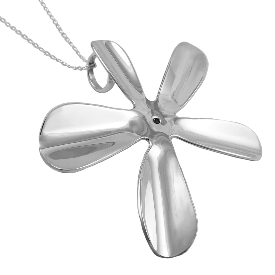 Silver daisy flower-shaped pendant on a white background