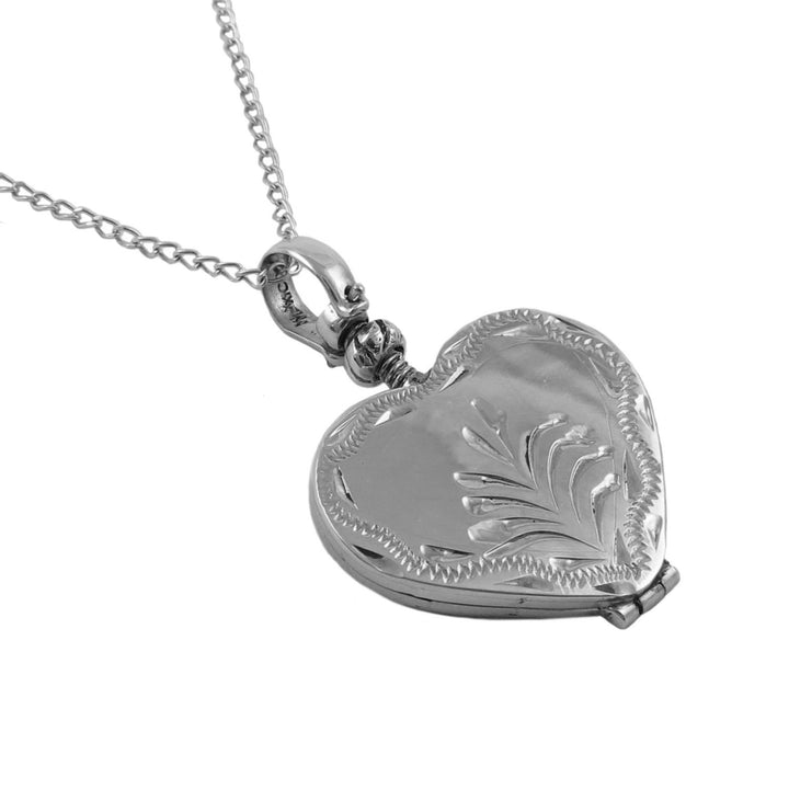 925 sterling silver heart-shaped locket with floral engraving hanging on a chain on a white background