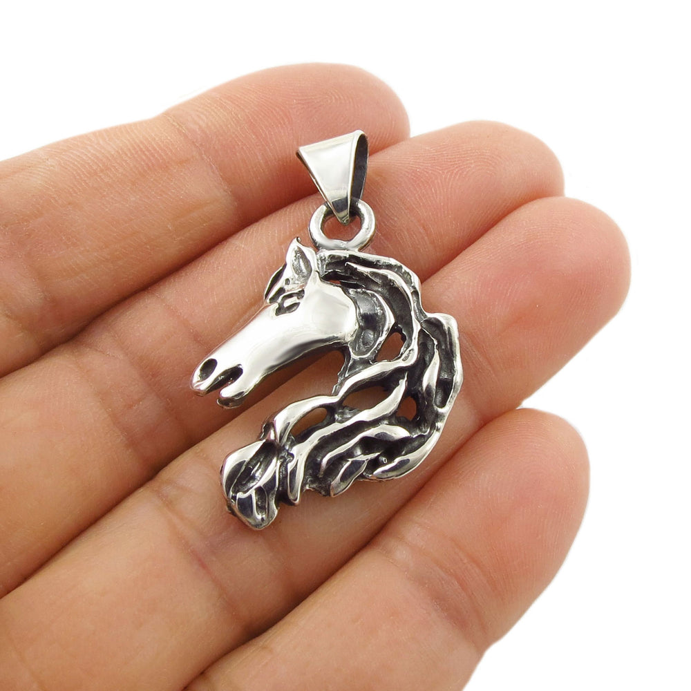 Horse Head pendant necklace in sterling 925 silver held in a person's hand