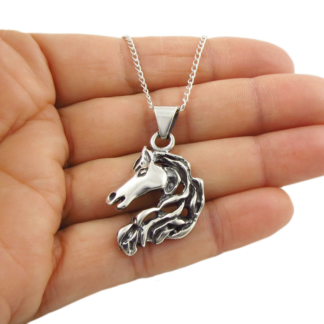 Sterling 925 Silver equestrian horse pendant necklace held in a hand against a white background