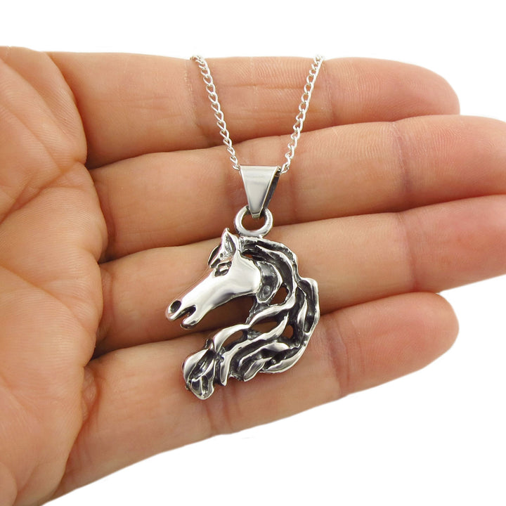 Sterling 925 Silver equestrian horse pendant necklace held in a hand against a white background