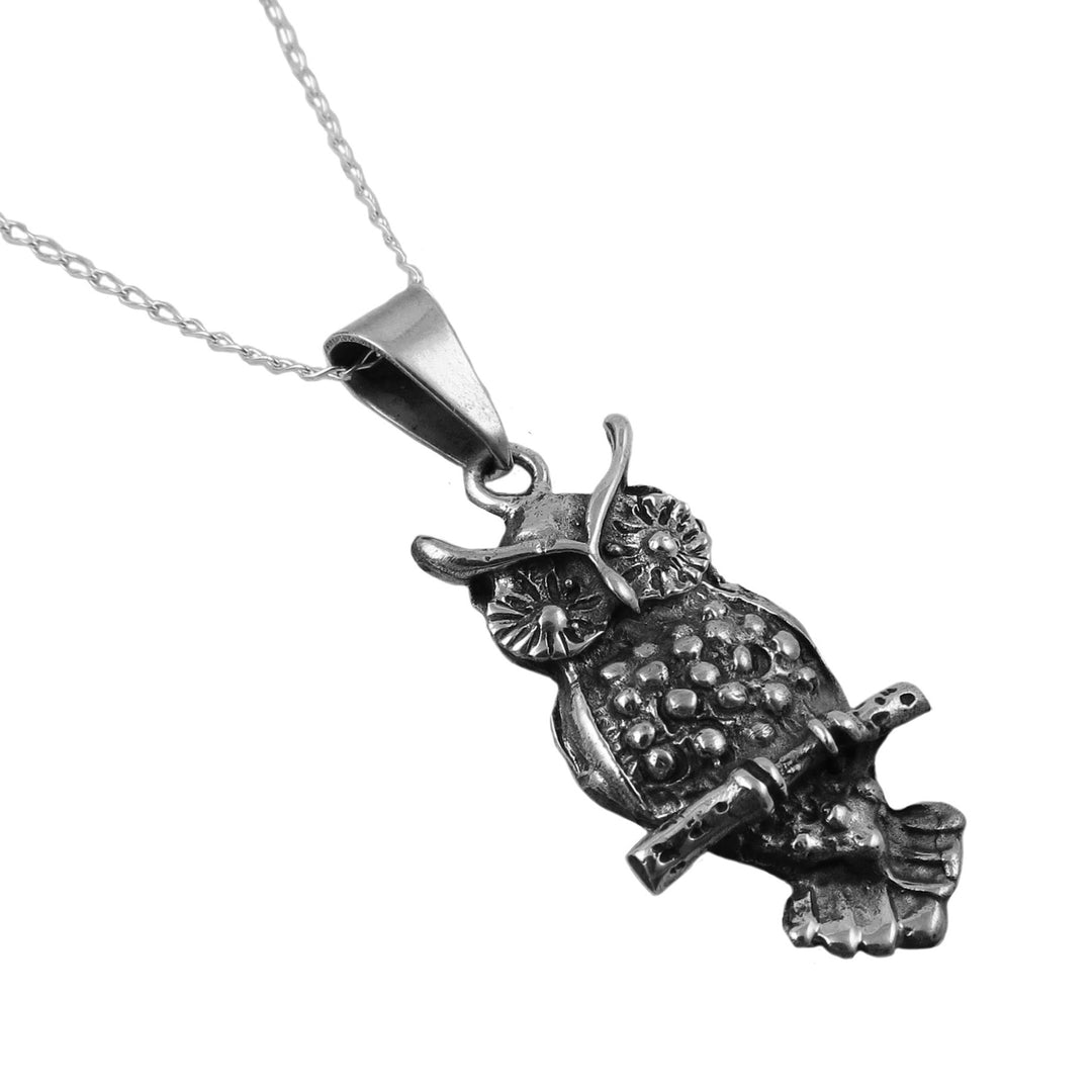 Silver owl pendant on a white background