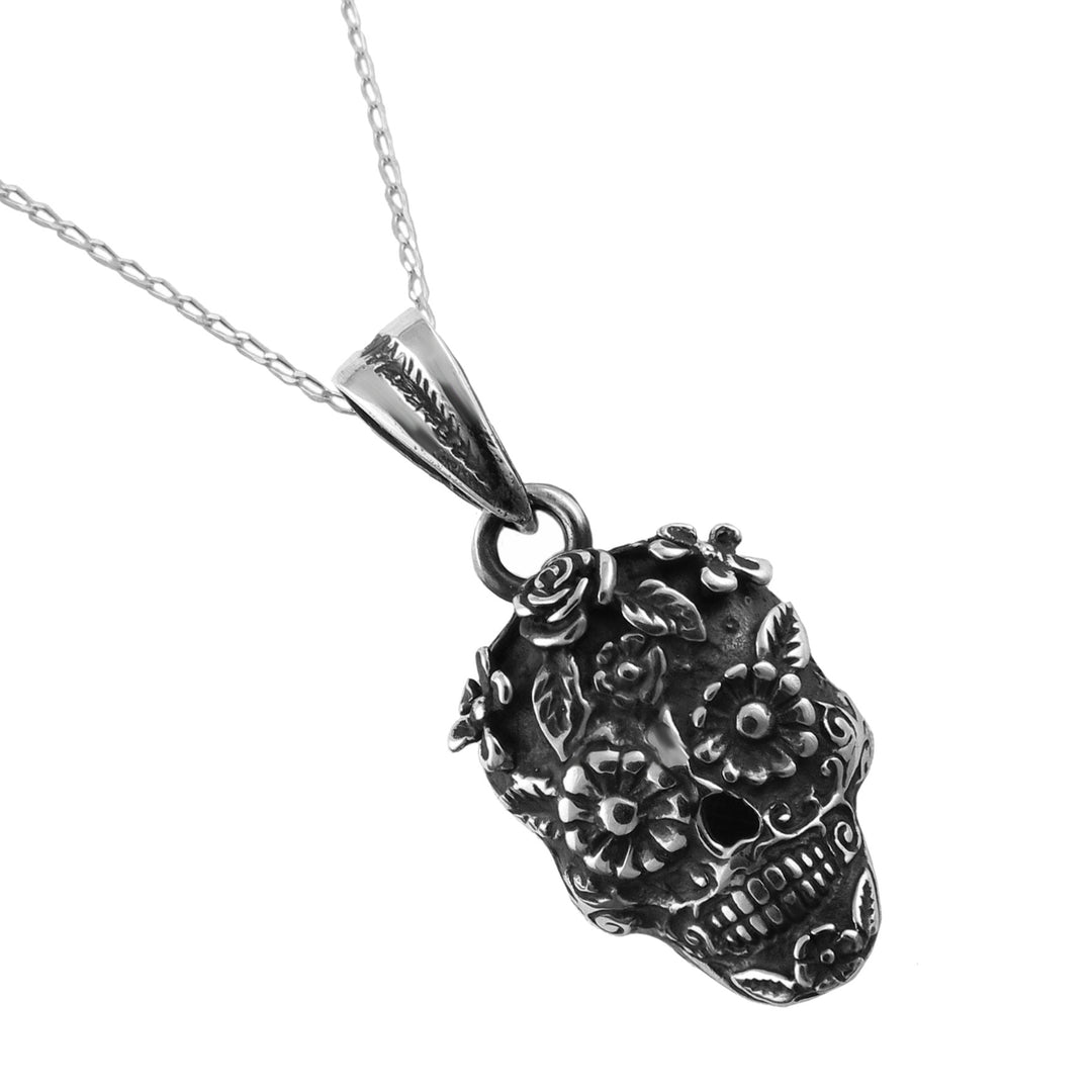 A hallmarked sterling 925 silver Mexican day of the dead sugar skull pendant necklace with floral engravings, shown on a clean white background.