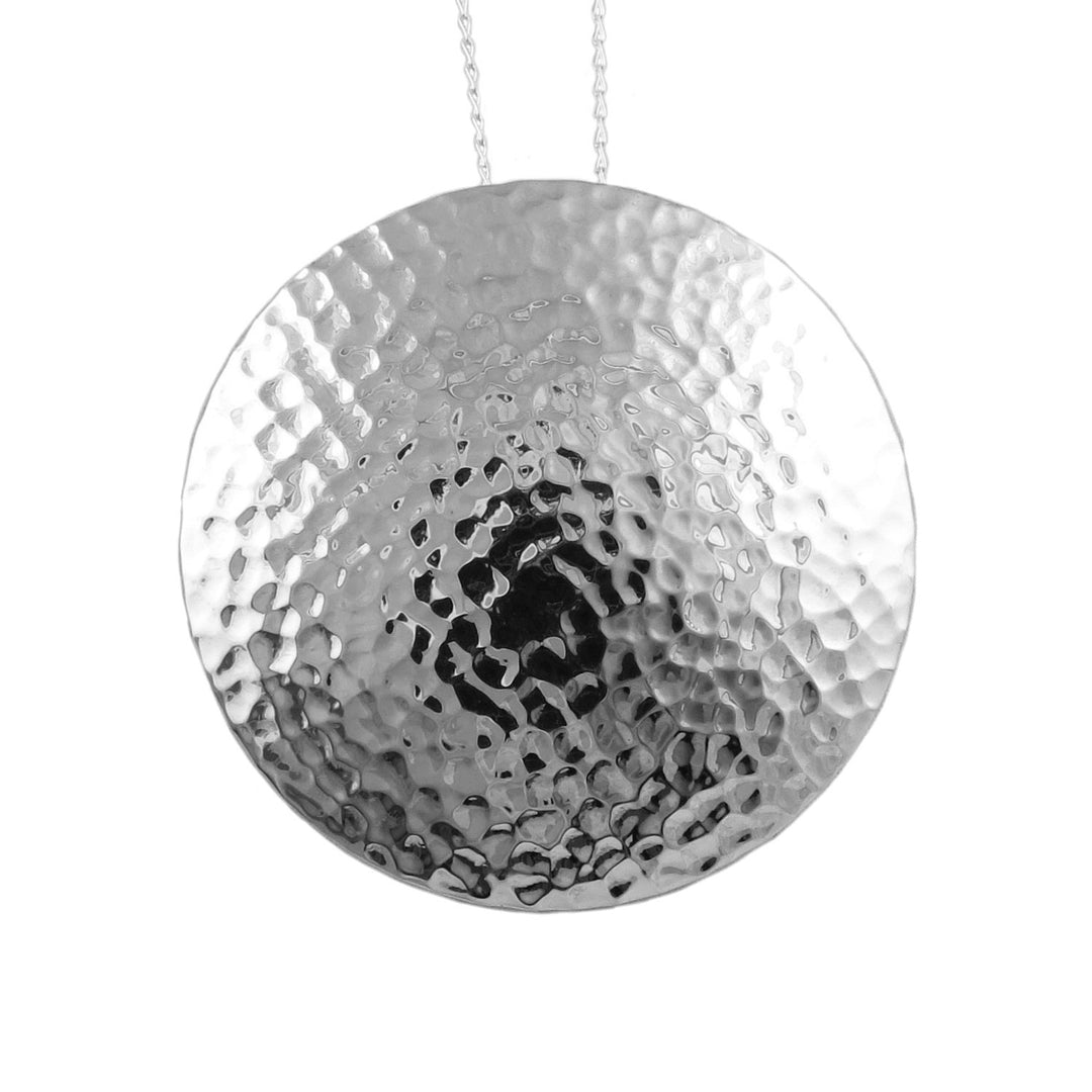 A large over-sized hammered sterling 925 silver pendant jewellery on a white background