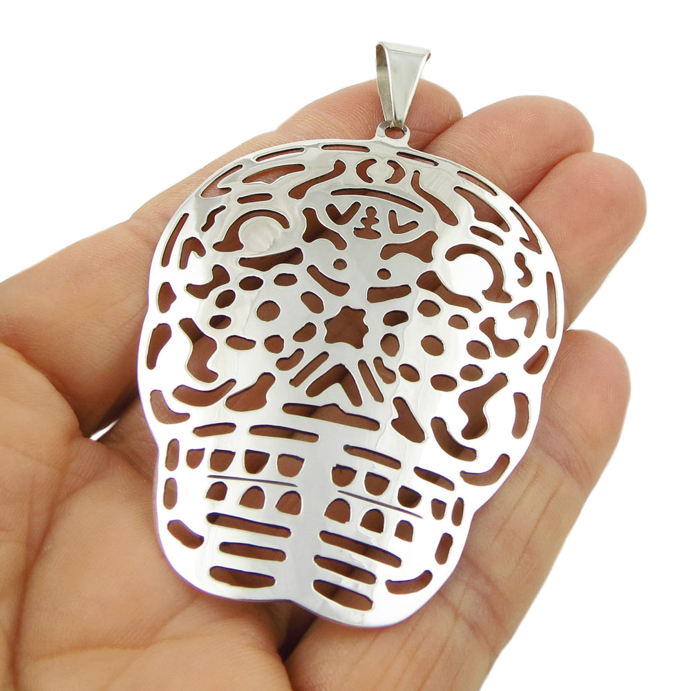Large Mexican day of the dead 925 sterling silver pendant necklace for women held in a person's hand on a white background. 