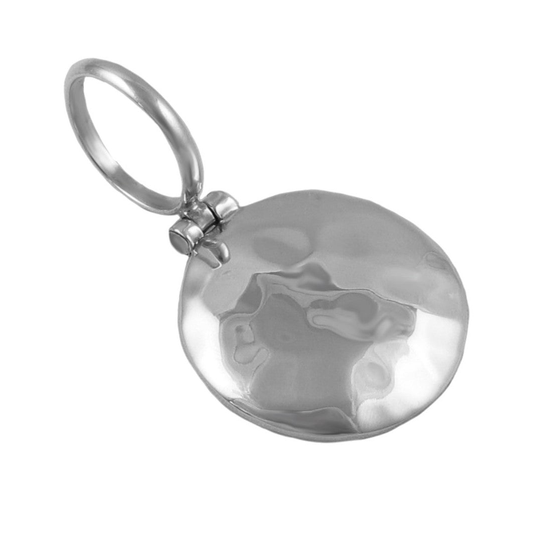 A round silver pendant with a hammered finish and a large over-szied bail on a white background. 