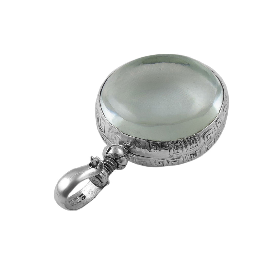 A large sterling silver locket pendant with clear glass on a white background. 