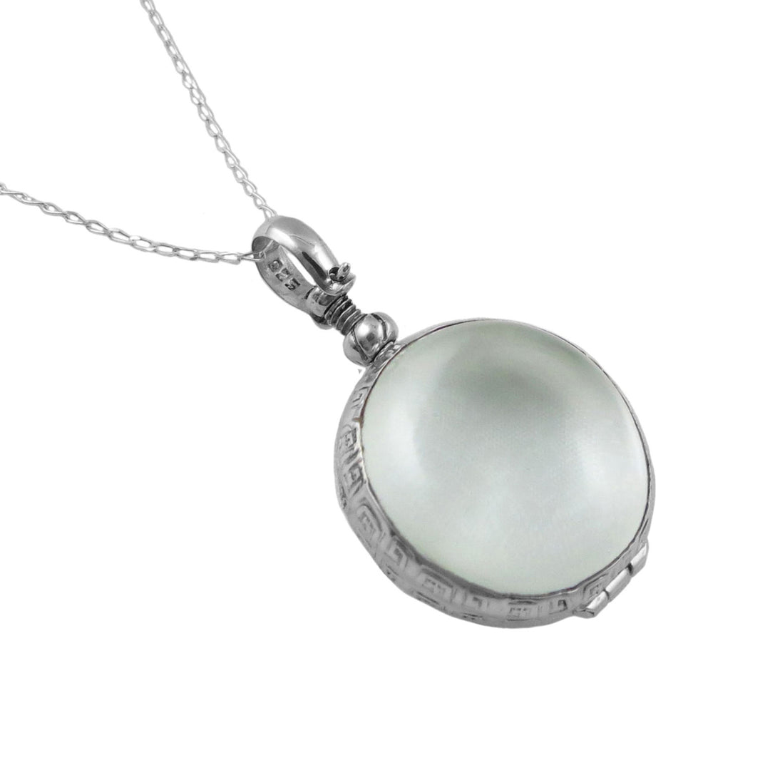 A large UK hallmarked 925 sterling silver pendant locket hanging on a silver curb chain against a white background. 