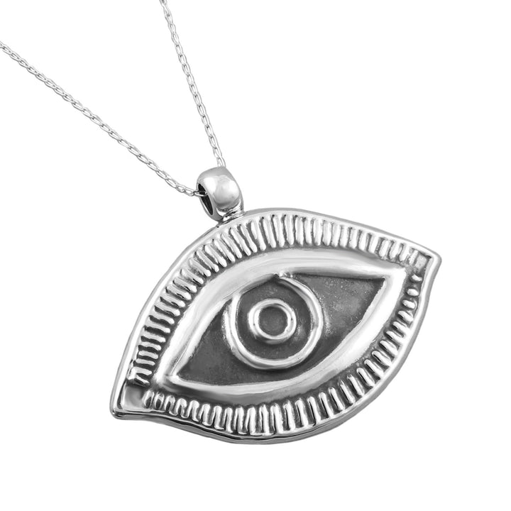 A Mexican 925 sterling silver magic eye pendant necklace with a textured, raised design and a matching delicate chain, shown on a plain white background.